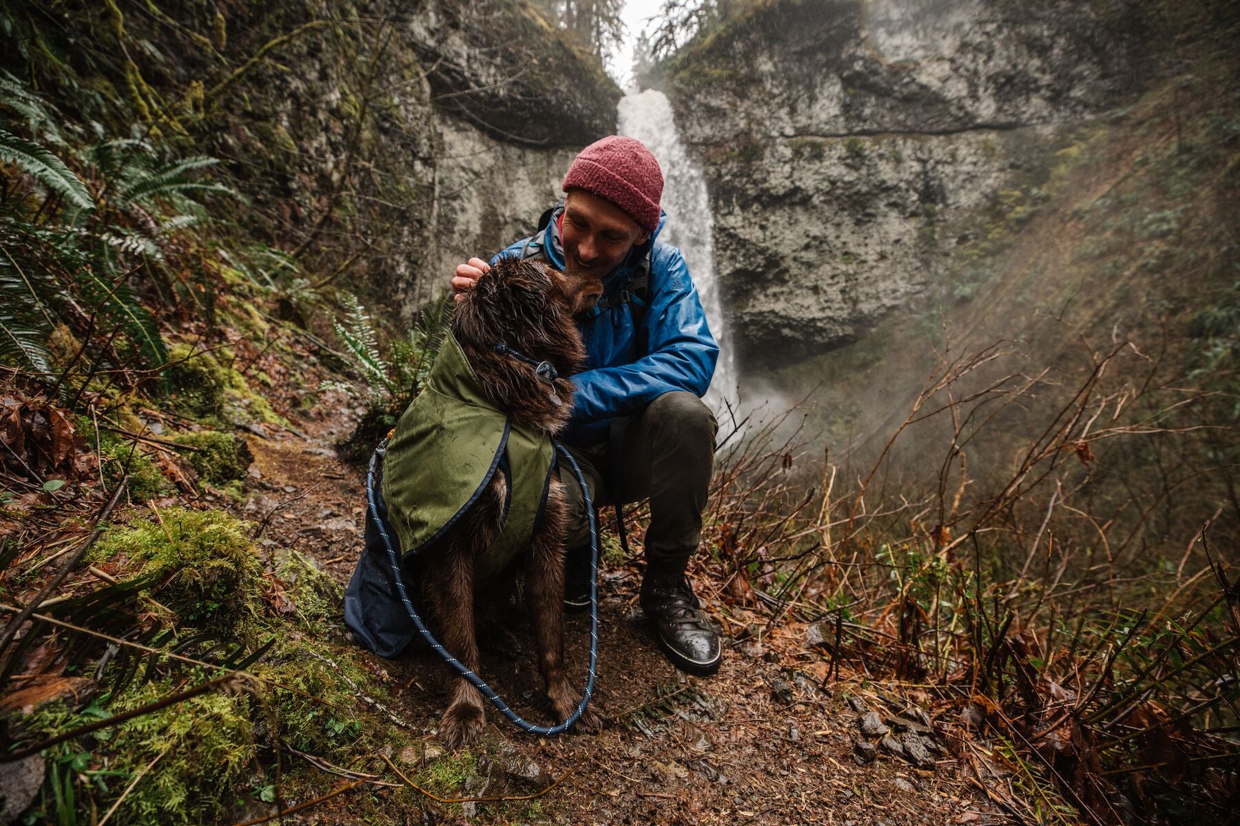 Dog wearing Ruffwear Sun Shower raincoat in wet weather